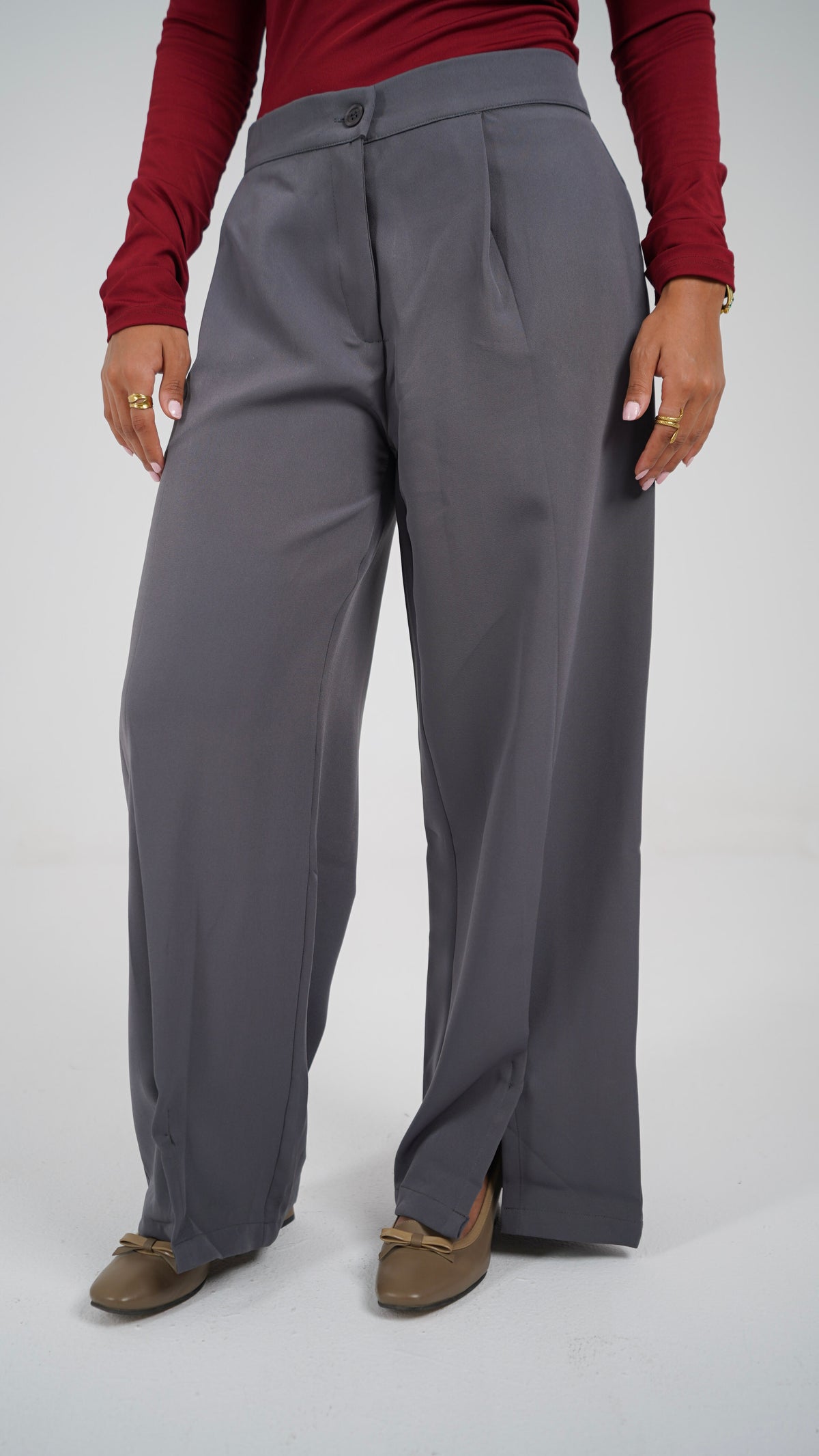 The Everyday Pants in grey, front, showing the pleats and the hem slit