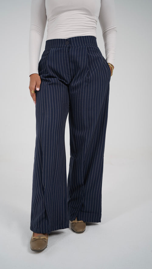 The Navy Pinstripe Pants, front, hand in the side pocket