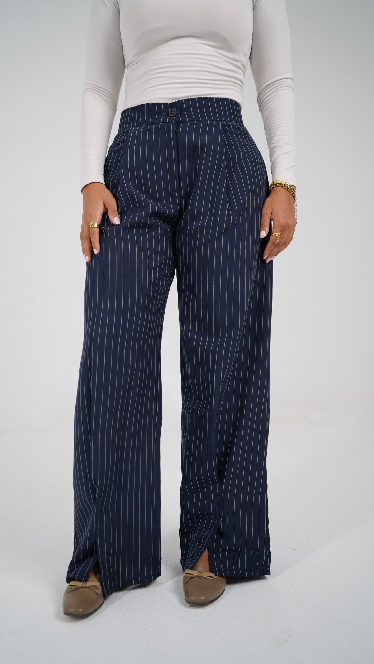 The Navy Pinstripe Pants, front, showing the hem slits